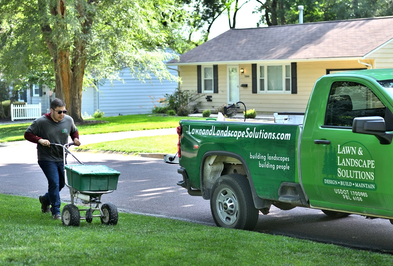 Owner's hand on his lawn feeling the soft, thick grass in Overland Park, KS.