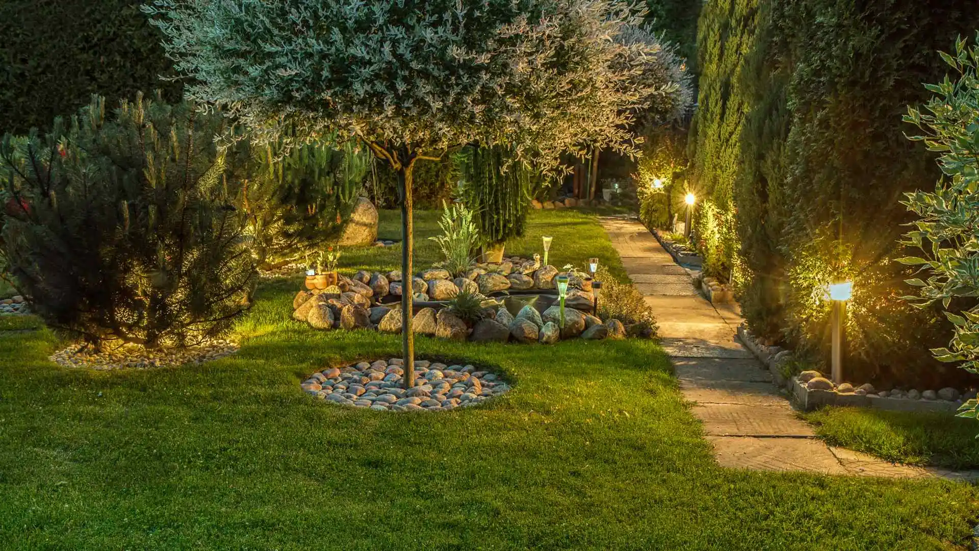 Landscape lighting illuminating a beautiful path and property at night in Overland Park, KS.