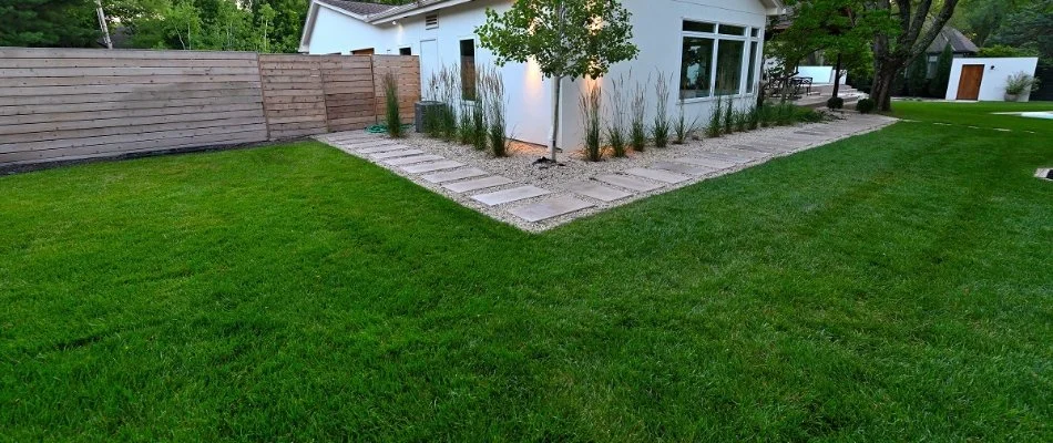 Backyard in Overland Park, KS, with a green lawn.