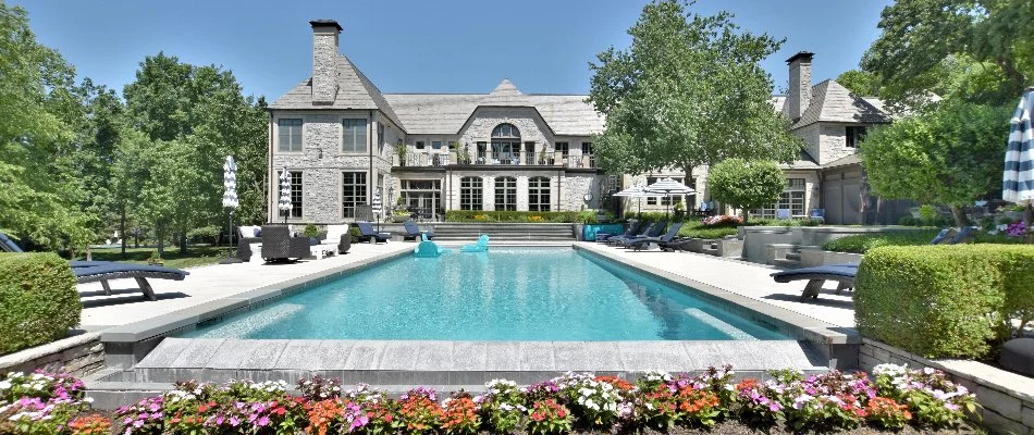 Beautiful home with a pool and flowers in Overland Park, KS.