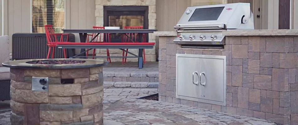 Fire pit near an outdoor kitchen in Overland Park, KS.