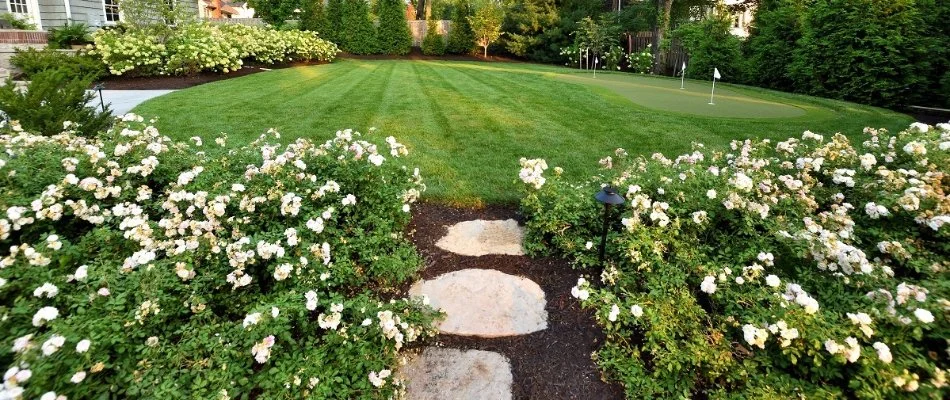 Landscape in Overland Park, KS, with flowers around a lawn.