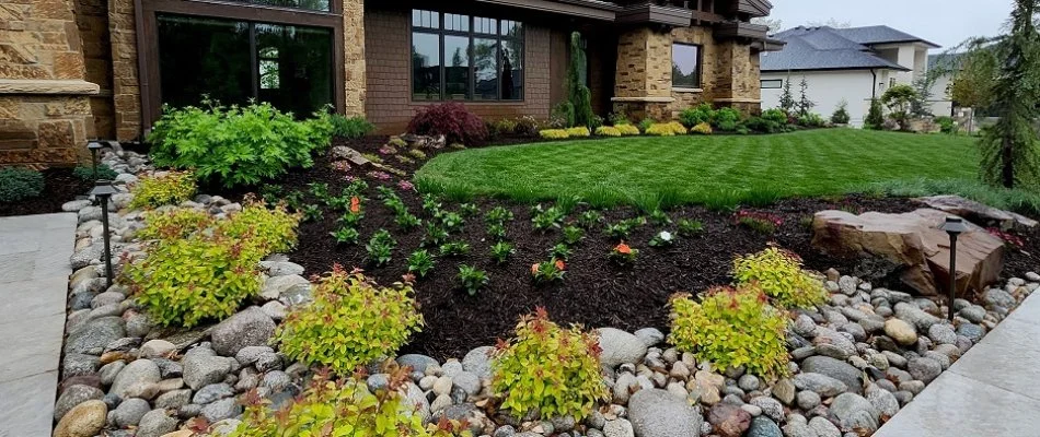 Mulched landscape area in Overland Park, KS, beside a lawn.