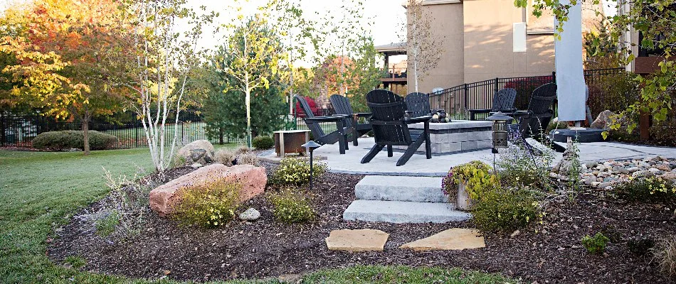 Mulched landscaping with plants around a patio in Overland Park, KS.