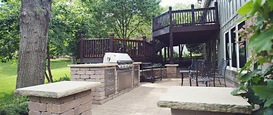 Outdoor kitchen in Overland Park, KS, on a patio near a deck.