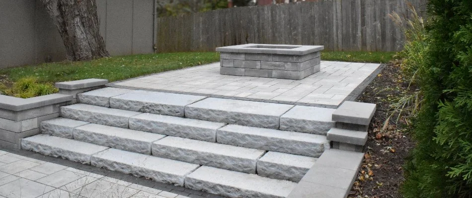 Outdoor steps in Overland Park, KS, leading to a patio with a fire pit.