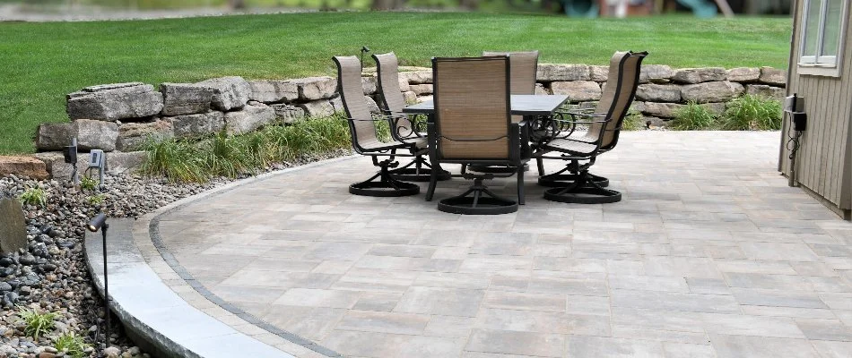 Patio in Overland Park, KS, with chairs near a retaining wall.