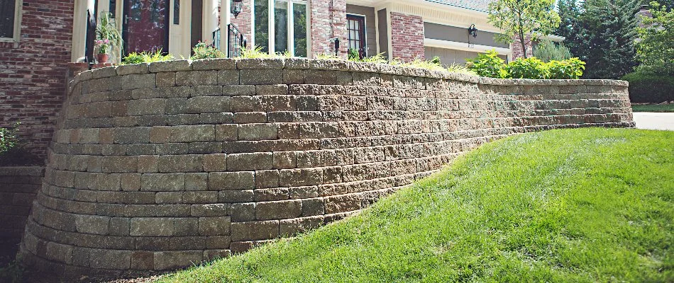 Retaining wall beside a sloped green lawn in Overland Park, KS.
