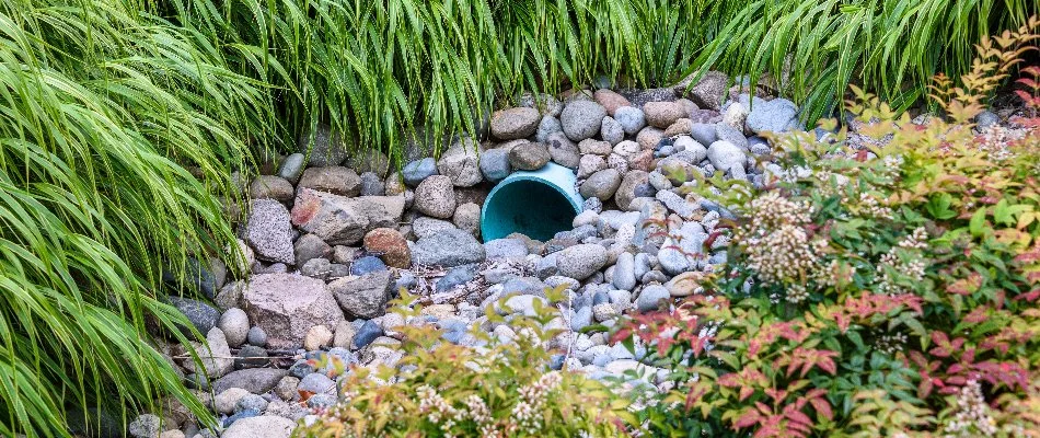 Rocks around a French drain pipe in Overland Park, KS.