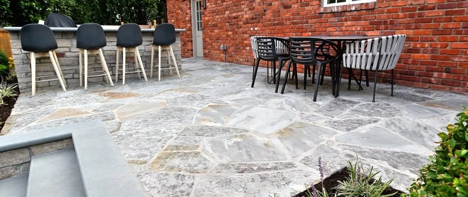 Stone patio in Overland Park, KS, with table and chairs.