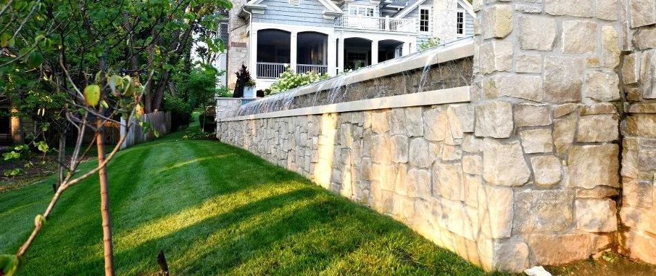 Stone retaining wall with a waterfall in Overland Park, KS.