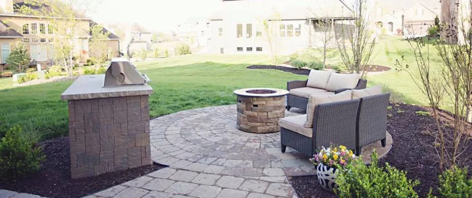 Circular fire pit in front of outdoor furniture on a patio in Overland Park, KS.