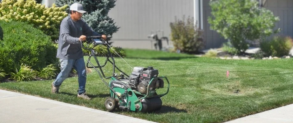 Crew aerating a lawn in Louisburg, KS.