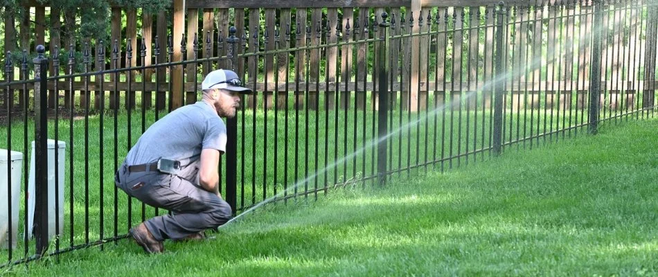 Crew member working on an irrigation system on a property in Overland Park, KS.
