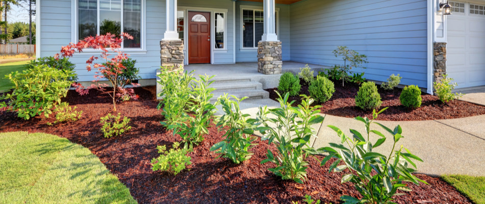 Gorgeous home with lovely new plants and red mulch in Overland Park, KS.