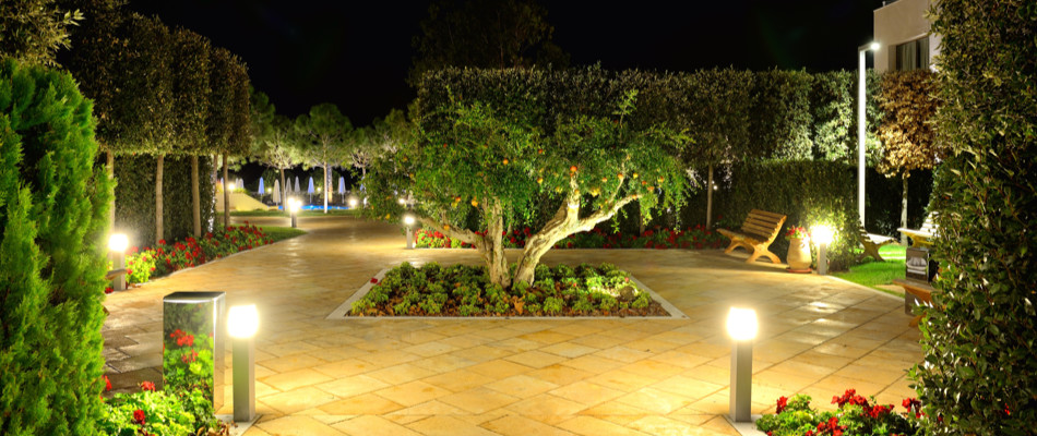 Landscape lighting all over a patio and walkway.