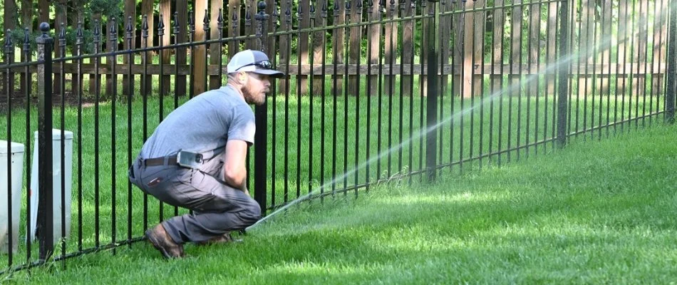 Professional performing irrigation maintenance in Louisburg, KS.