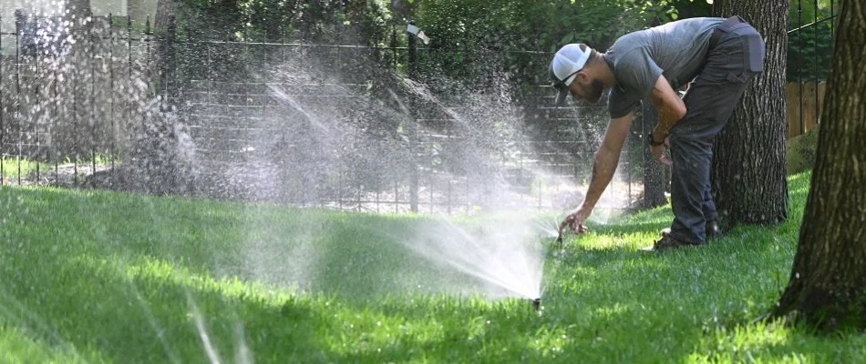 Tech inspecting sprinkler heads in Greenwood, MO.